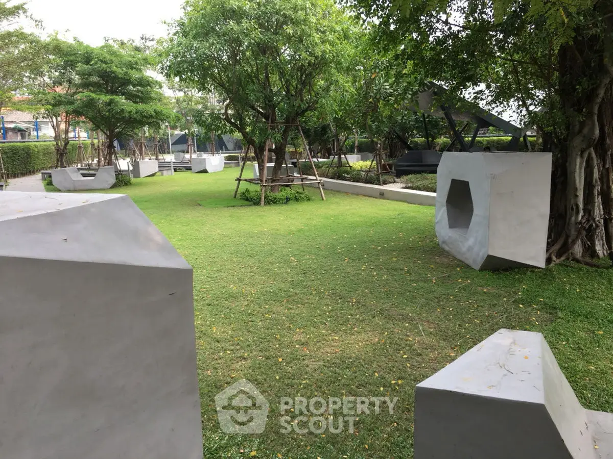 Modern garden with geometric concrete sculptures and lush greenery