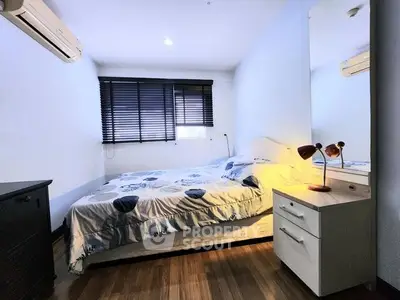 Cozy bedroom with modern decor and ample natural light