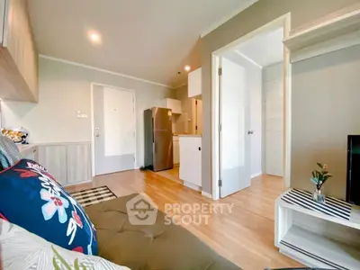 Modern living room with open kitchen and stylish decor in a cozy apartment.