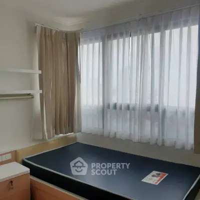 Cozy bedroom with large windows and natural light in modern apartment