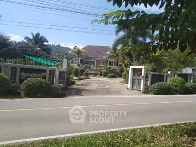 Charming suburban house with lush garden and gated entrance, perfect for family living.