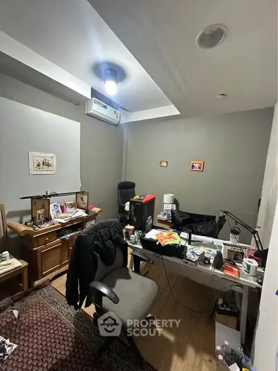 Cozy home office with modern lighting and air conditioning, perfect for productivity.
