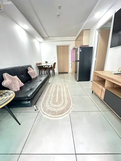 Modern living room with sleek furniture and open kitchen layout