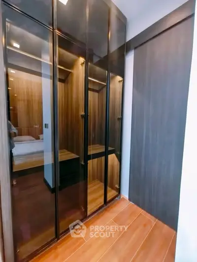 Spacious walk-in closet with elegant wooden finishes and ample storage space.