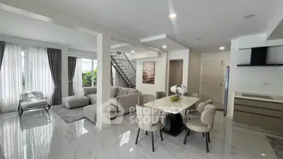 Spacious modern living and dining area with elegant decor and natural light.