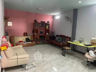 Spacious living room with modern furniture and vibrant wall colors, perfect for family gatherings.