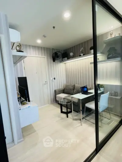 Modern living room with stylish decor and glass partition in cozy apartment