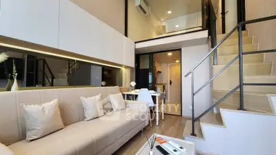 Modern duplex apartment with stylish living room and open staircase