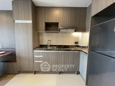 Modern kitchen with sleek cabinetry and built-in appliances in a stylish apartment.