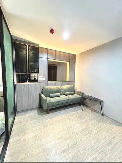 Modern living room with stylish sofa and wooden flooring in a cozy apartment.