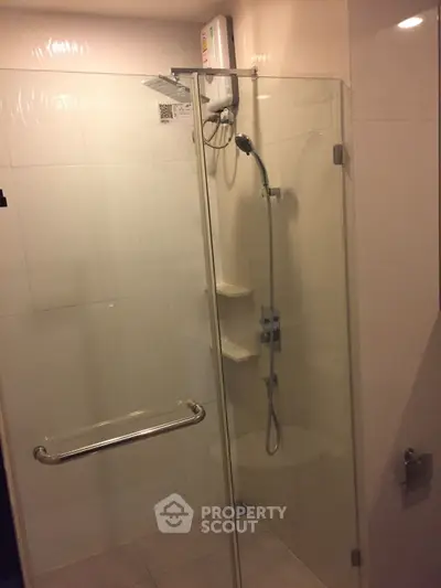 Modern bathroom with glass shower enclosure and sleek fixtures