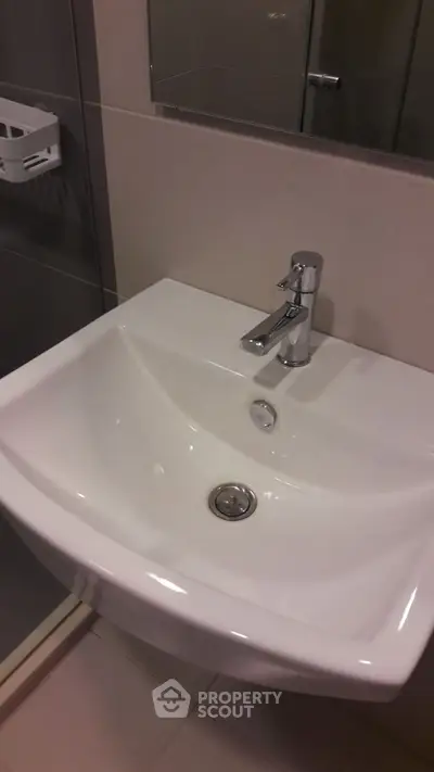 Modern bathroom sink with sleek faucet in contemporary design.