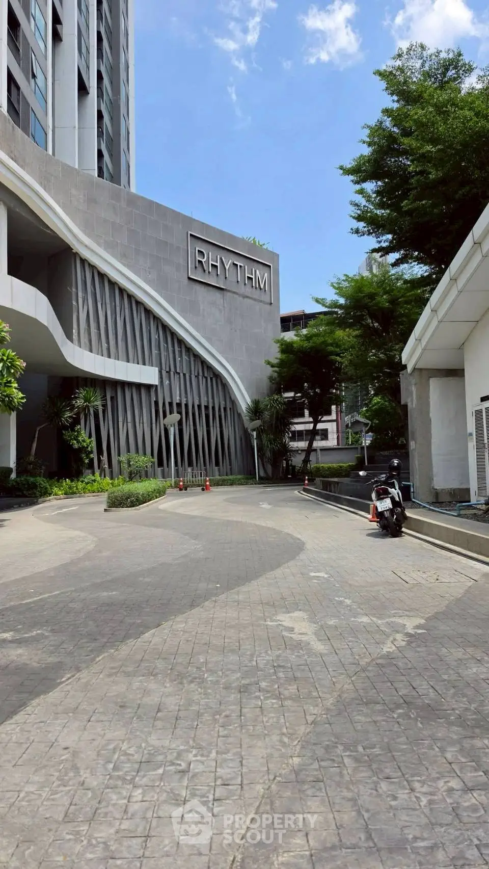 Modern building exterior with unique architectural design and lush greenery