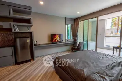 Modern bedroom with sleek design and balcony access, featuring a cozy bed and stylish decor.