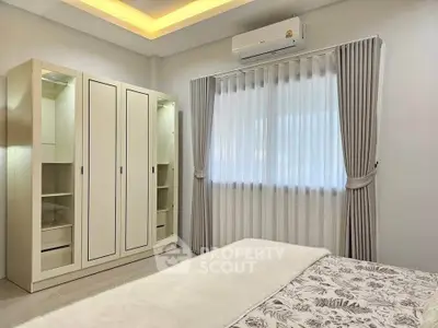 Cozy bedroom with modern wardrobe and elegant curtains