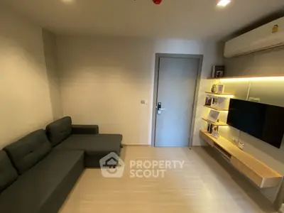 Modern living room with sleek furniture and wall-mounted TV unit