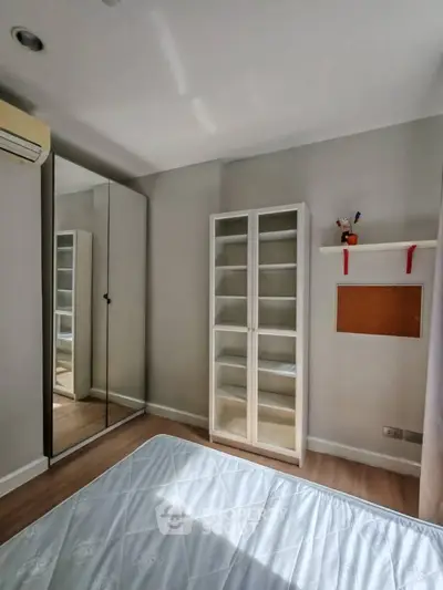Cozy bedroom with mirrored wardrobe and minimalist decor