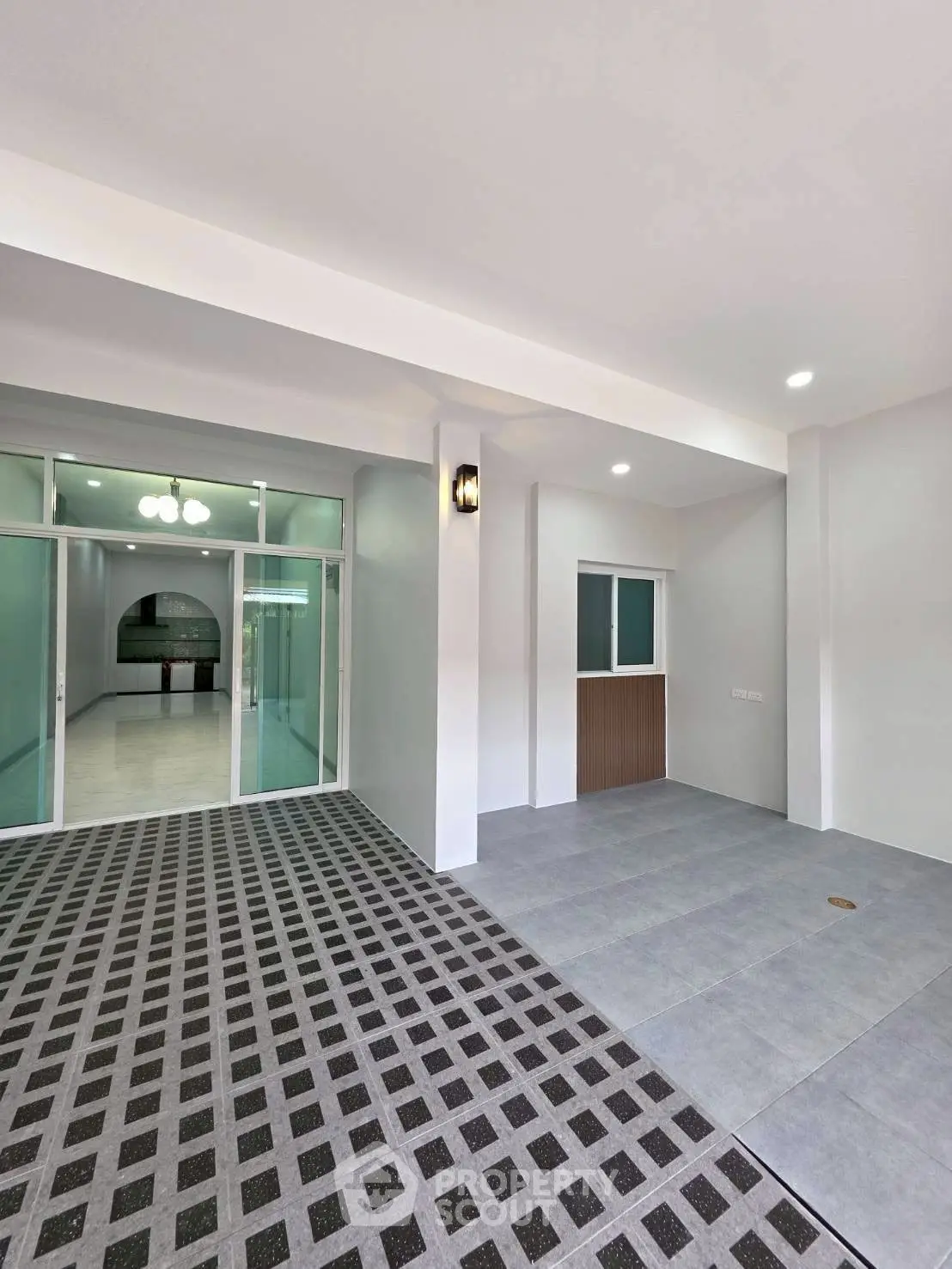 Spacious modern entrance with stylish flooring and elegant lighting