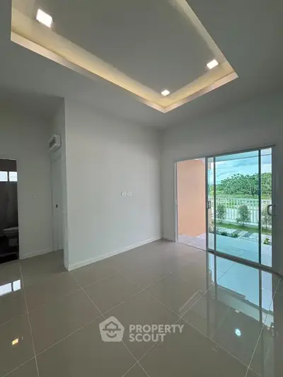 Spacious modern living room with glossy tiles and balcony access, perfect for natural light lovers.