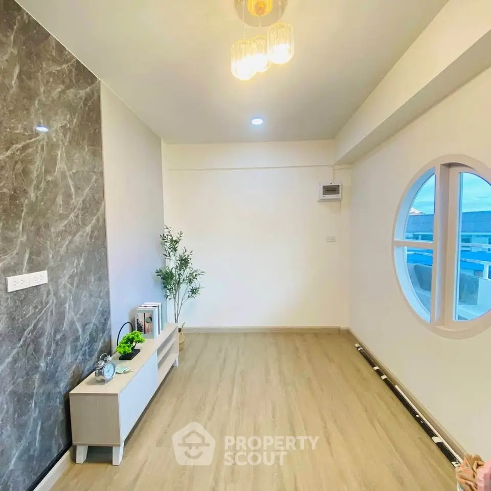 Modern living room with stylish decor and unique round window design