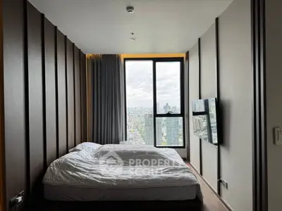 Modern bedroom with large window offering stunning city views, featuring sleek design and wall-mounted TV.