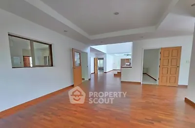 Spacious open layout living area with wooden flooring and modern design