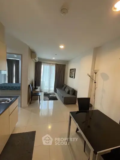 Modern apartment interior with open layout, featuring a cozy living area and stylish furnishings.