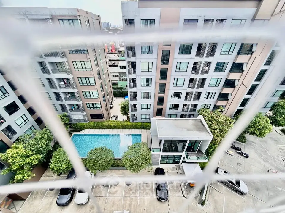 Modern apartment complex with pool and parking, offering urban living with great amenities and city views.