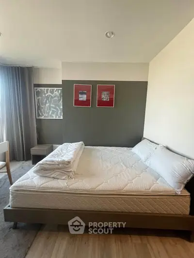Modern bedroom with stylish decor and large window for natural light.