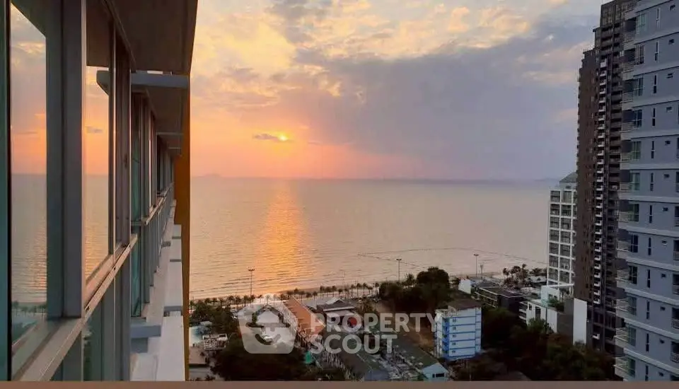 Stunning ocean view from high-rise building at sunset, perfect for luxury living.