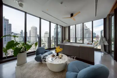 Luxurious living room with panoramic city views, modern furniture, and elegant decor in a high-rise apartment.