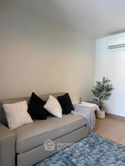 Cozy living room with modern sofa and air conditioning unit