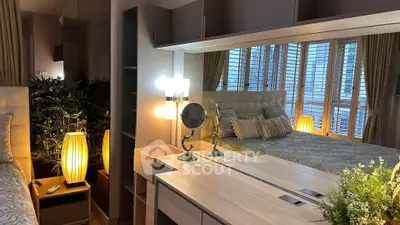 Luxurious bedroom with elegant decor and ambient lighting, featuring a stylish vanity and plush bedding.