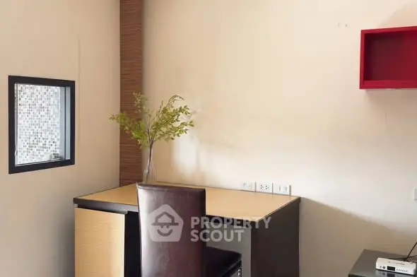 Modern study room with sleek desk and stylish chair, perfect for productivity.