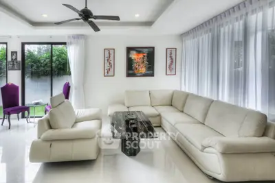 Luxurious modern living room with white leather sofas and elegant decor