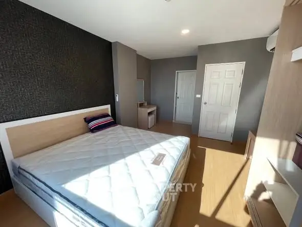 Spacious bedroom with modern decor and ample natural light