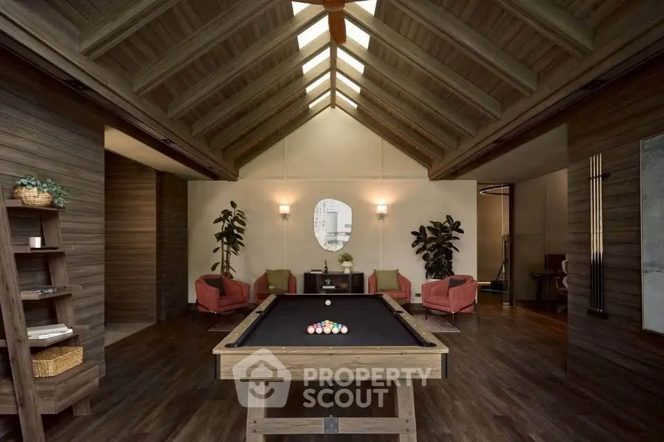 Luxurious living room with vaulted ceiling and pool table, perfect for entertainment and relaxation.