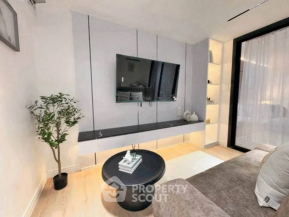 Modern living room with sleek TV setup and cozy seating area
