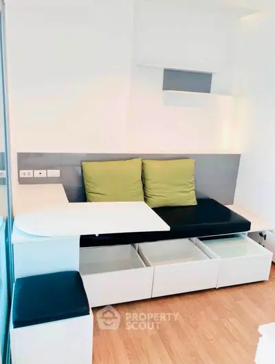 Modern living room with sleek built-in storage and stylish seating area.