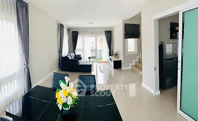 Spacious modern living room with elegant dining area and sleek kitchen