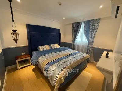 Cozy bedroom with stylish decor and large bed in modern apartment
