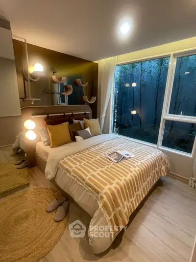 Cozy bedroom with modern decor and large window overlooking serene garden view.