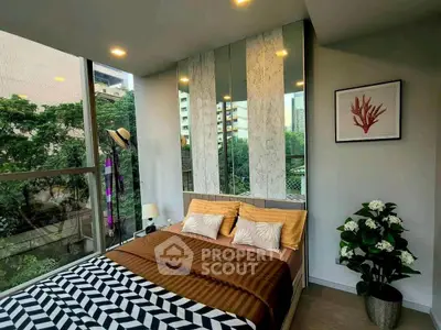 Modern bedroom with large windows and stylish decor in urban setting.