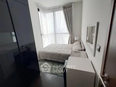 Modern bedroom with large window and stylish decor