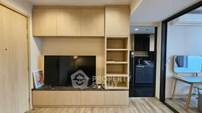 Modern living room with built-in TV unit and open kitchen layout