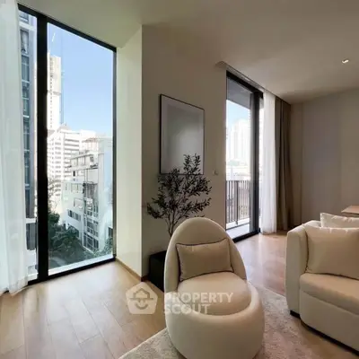 Modern living room with floor-to-ceiling windows and city view, featuring stylish furniture and wooden flooring.