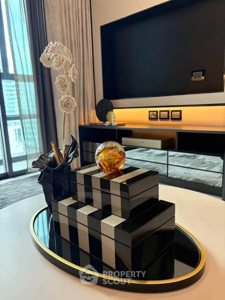 Elegant modern living room with stylish decor and large window view.