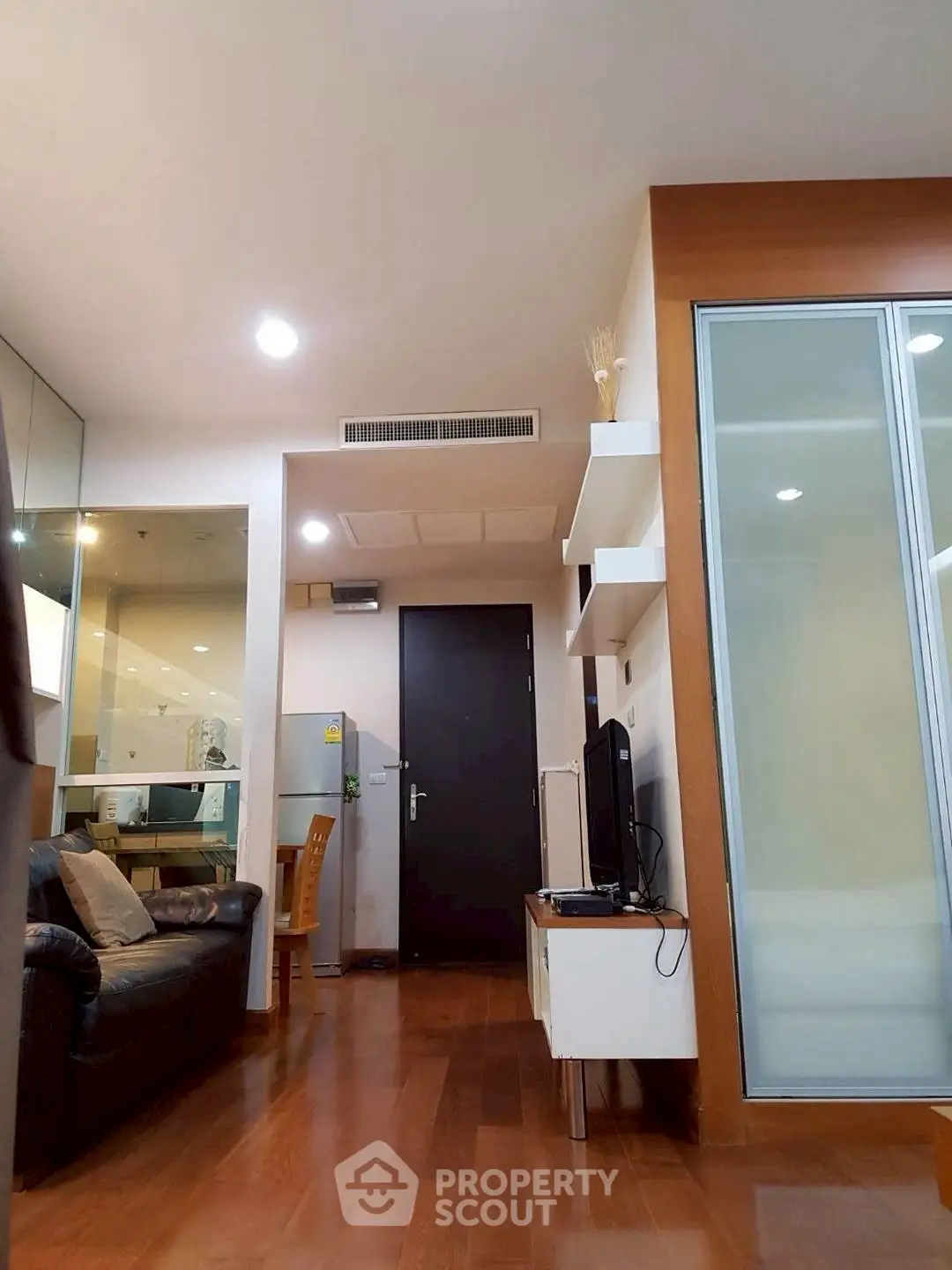 Modern living room with sleek design and open layout, featuring hardwood floors and contemporary furniture.