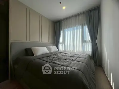 Modern bedroom with large window and elegant curtains, featuring a cozy double bed.