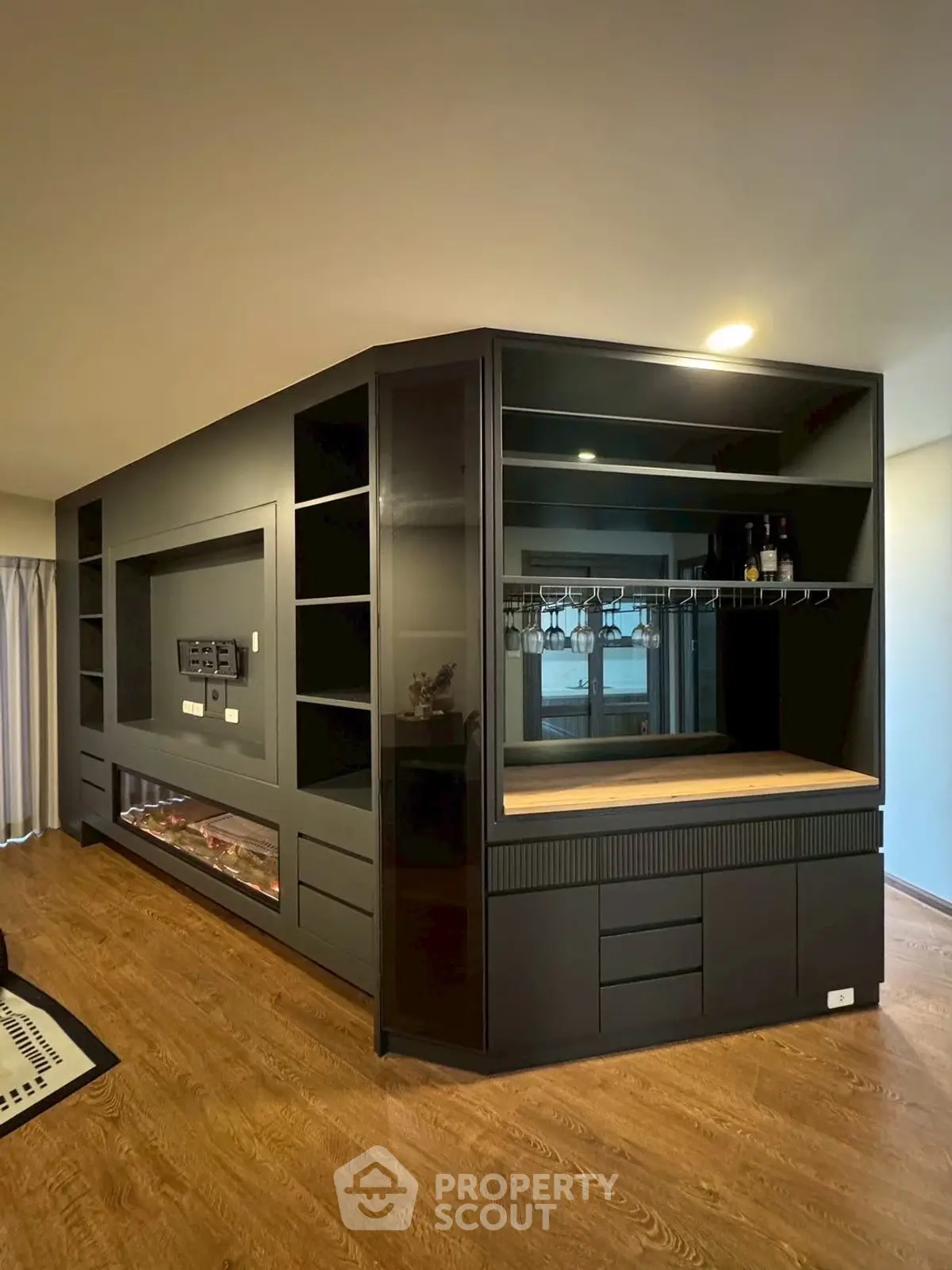 Modern interior with sleek black cabinetry and wooden flooring, perfect for stylish living spaces.